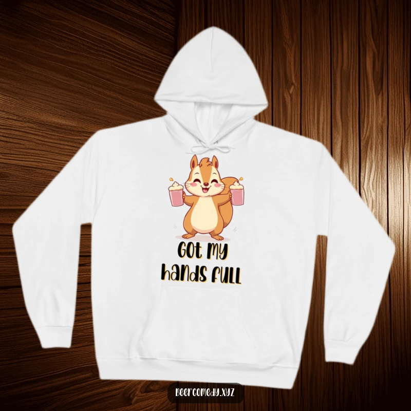 A cheerful squirrel is depicted in the act of juggling three frothy mugs, printed on a soft and warm hoodie.